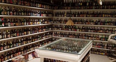 Thousands of beer bottles lined up on basement shelves